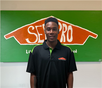 Man in front of Servpro sign