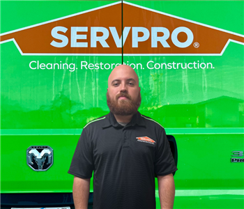 tech in front of Servpro sign