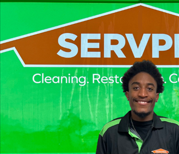 man in front of Servpro sign